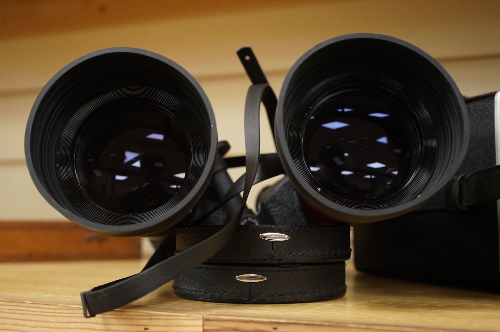 A cased pair of Vixen B Type 10x70 binoculars, stamped ‘Waterproof’, B4 Field 5.3 ‘92M at 1000M’, serial no. 303K050, with rubber shade guards, lens caps and integral tripod mounting, binoculars 27cm long, with the origi